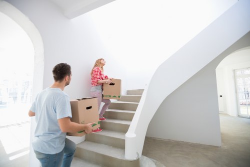 Moving team handling furniture in a Battersea apartment building